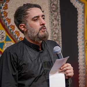 حسین دارد کودکش را در عبا پنهان کند